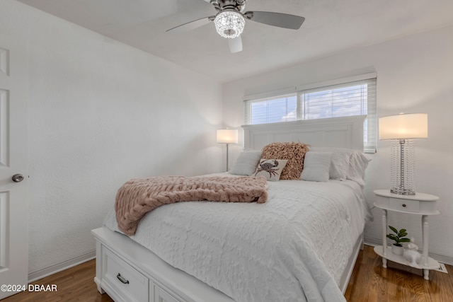 bedroom featuring ceiling fan and dark hardwood / wood-style flooring