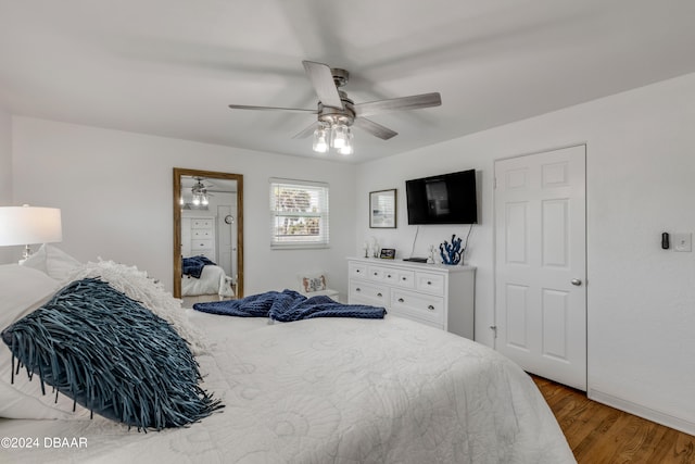 bedroom with ceiling fan and wood-type flooring