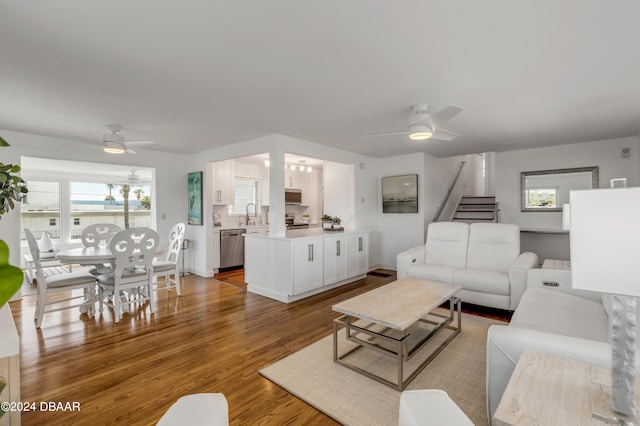 living room featuring hardwood / wood-style floors, a healthy amount of sunlight, and ceiling fan