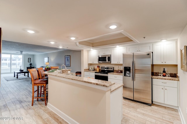 kitchen featuring light hardwood / wood-style flooring, white cabinetry, and stainless steel appliances