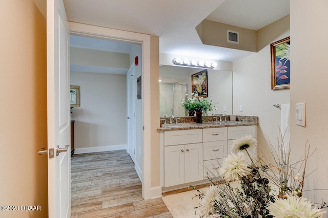 bathroom featuring vanity and wood-type flooring