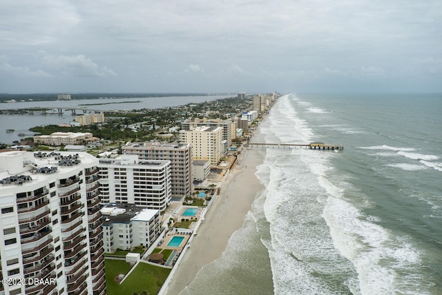 birds eye view of property with a water view and a view of the beach