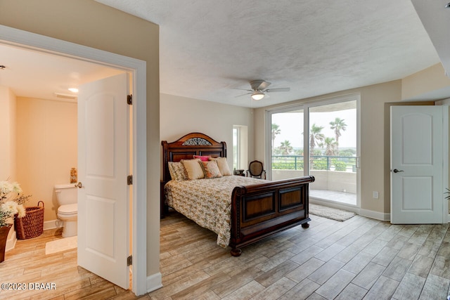 bedroom featuring ceiling fan, connected bathroom, light hardwood / wood-style flooring, and a textured ceiling