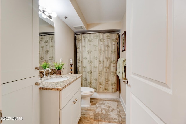 bathroom featuring toilet and vanity