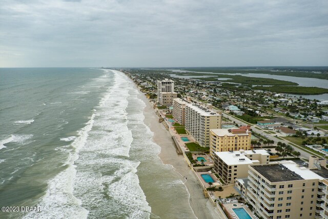 drone / aerial view with a beach view and a water view