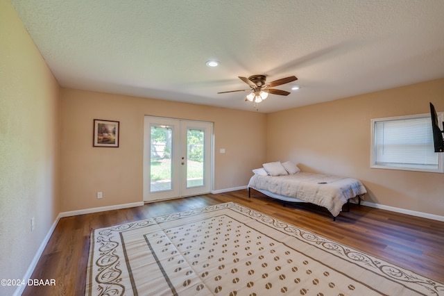 bedroom with access to outside, hardwood / wood-style floors, ceiling fan, and a textured ceiling