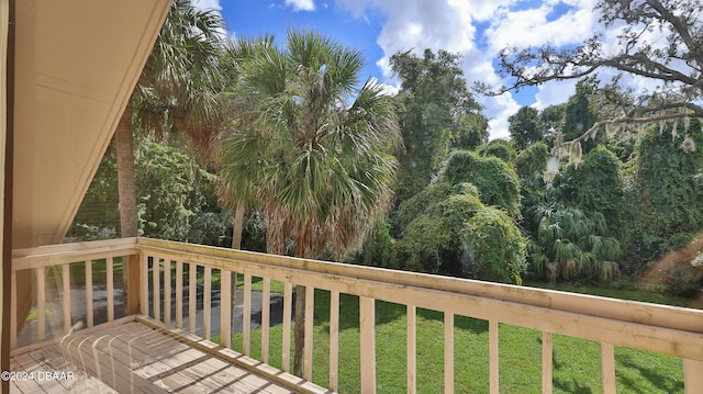 wooden deck featuring a yard