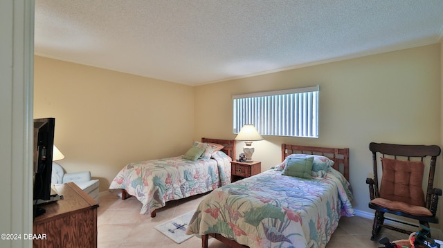 tiled bedroom with a textured ceiling