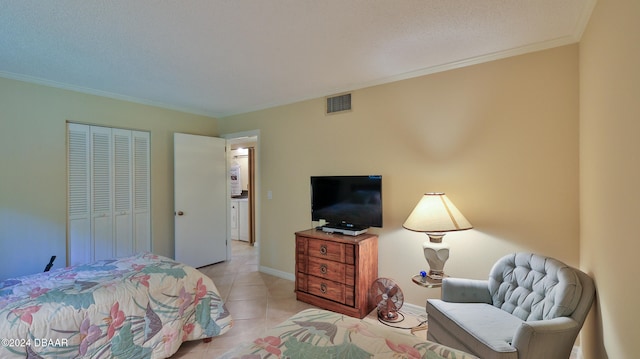 tiled bedroom with a closet and crown molding