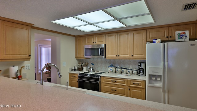 kitchen featuring white refrigerator with ice dispenser, backsplash, light brown cabinets, sink, and black range with electric stovetop