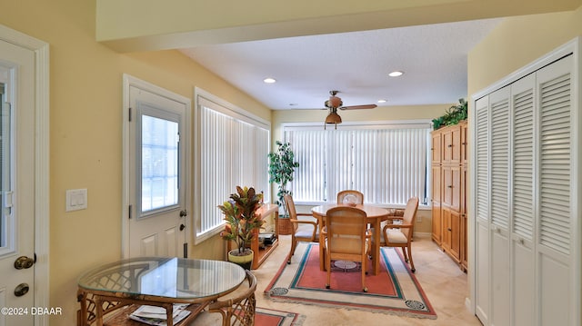 dining space featuring a textured ceiling, ceiling fan, and light tile patterned floors