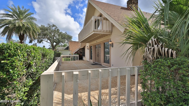 view of side of home with a balcony