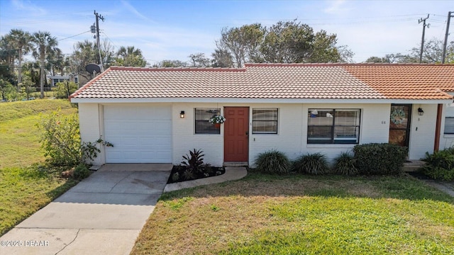 ranch-style house featuring a garage and a front lawn