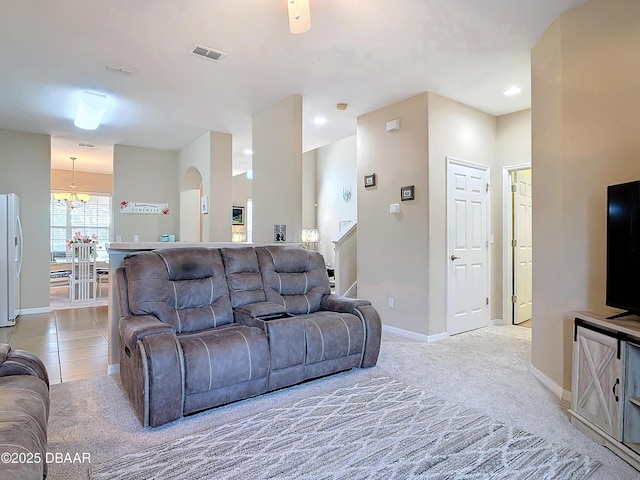 carpeted living room with a notable chandelier