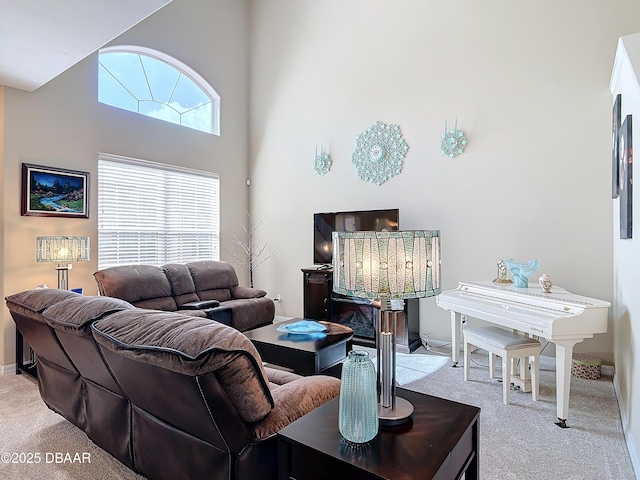 living room featuring a high ceiling and light carpet