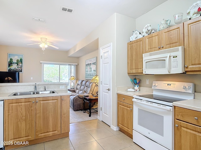 kitchen with visible vents, open floor plan, light countertops, white appliances, and a sink