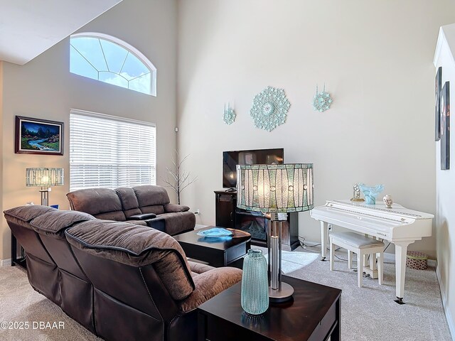 living room featuring a high ceiling and carpet floors