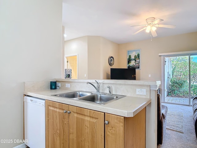 kitchen featuring sink, ceiling fan, carpet flooring, white dishwasher, and kitchen peninsula