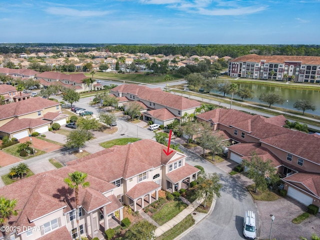 birds eye view of property featuring a residential view and a water view