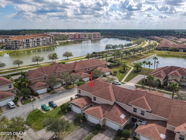 drone / aerial view featuring a water view and a residential view