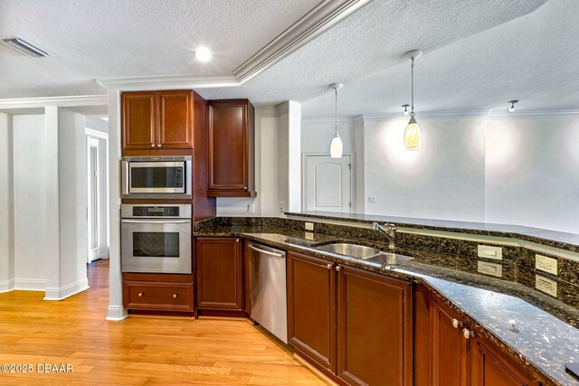 2515 S Atlantic Ave Unit 507, Daytona Beach Shores, FL 32118 - kitchen featuring appliances with stainless steel finishes, a textured ceiling, light wood-style floors, dark stone countertops, and decorative light fixtures
