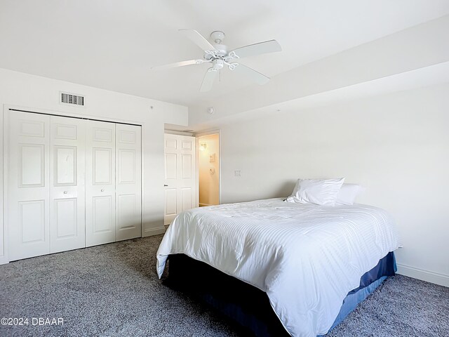 carpeted bedroom with ceiling fan and a closet