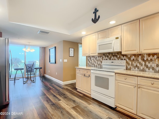 kitchen with dark hardwood / wood-style flooring, hanging light fixtures, a notable chandelier, backsplash, and white appliances