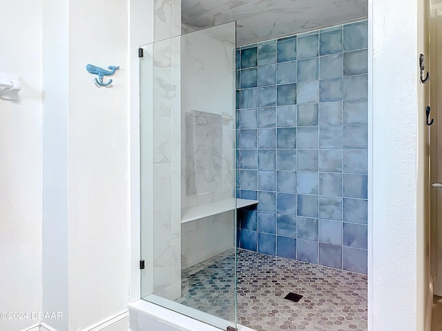 bathroom with tiled shower