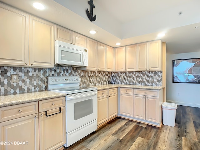 kitchen featuring white appliances, dark hardwood / wood-style floors, and tasteful backsplash