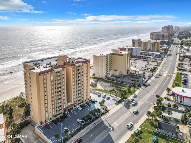 aerial view with a water view and a beach view