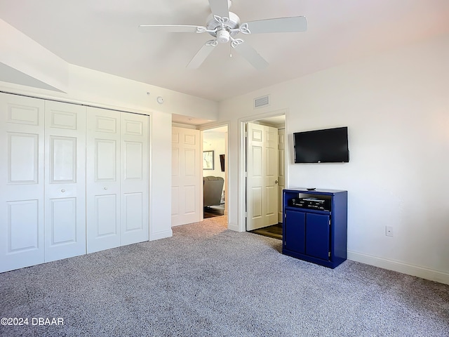 unfurnished bedroom with ceiling fan, a closet, and carpet floors