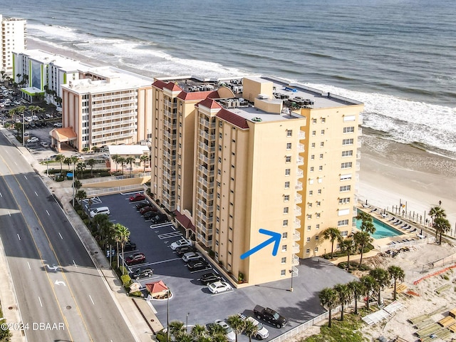 birds eye view of property featuring a water view and a beach view