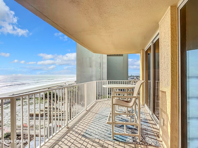 balcony with a view of the beach and a water view