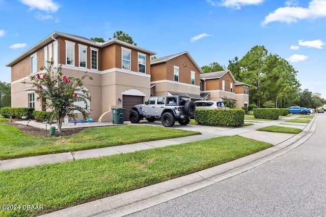 161 Tarracina Way, Daytona Beach, FL 32117 - townhome / multi-family property featuring an attached garage, stucco siding, driveway, and a front lawn