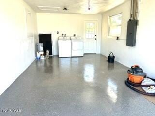 124 Harrison Rd, Daytona Beach, FL 32118 - garage with independent washer and dryer and electric panel