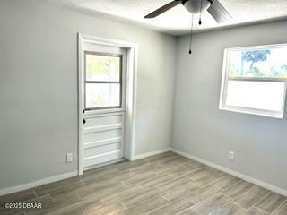 124 Harrison Rd, Daytona Beach, FL 32118 - unfurnished room featuring baseboards, ceiling fan, and light wood-type flooring