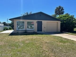 124 Harrison Rd, Daytona Beach, FL 32118 - view of front of property featuring an attached garage, driveway, and a front yard
