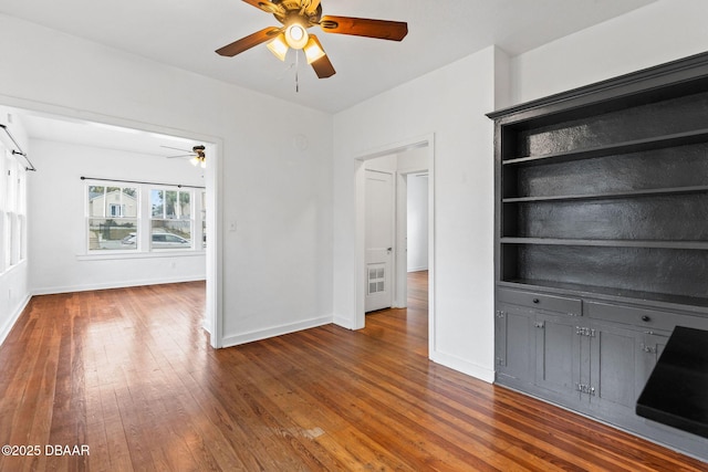 unfurnished living room featuring ceiling fan, baseboards, and hardwood / wood-style floors