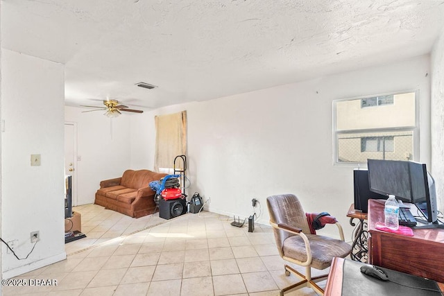 office area with light tile patterned floors, a textured ceiling, visible vents, and a ceiling fan