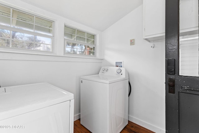washroom featuring dark wood-type flooring, independent washer and dryer, cabinet space, and baseboards