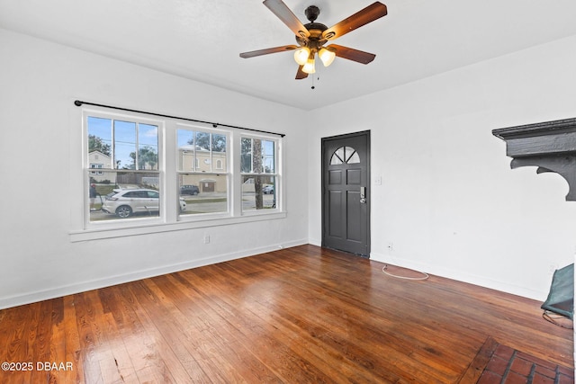foyer featuring ceiling fan, baseboards, and hardwood / wood-style flooring