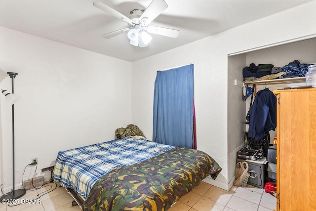 tiled bedroom featuring a ceiling fan and baseboards