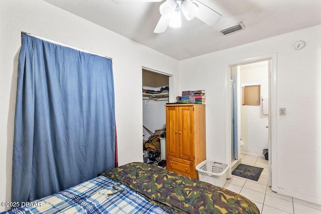 bedroom featuring light tile patterned floors, a closet, visible vents, and a ceiling fan
