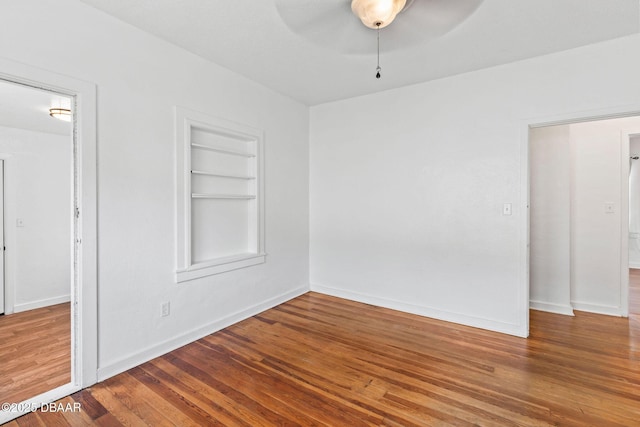 unfurnished bedroom featuring baseboards and wood finished floors