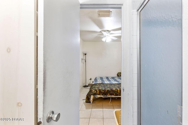 bedroom featuring light tile patterned floors and visible vents