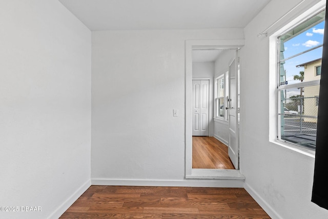 spare room with wood finished floors and baseboards