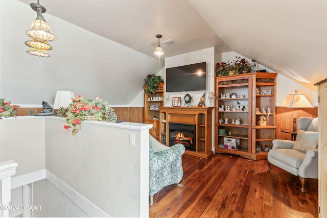 living room featuring wooden walls, dark hardwood / wood-style flooring, and lofted ceiling