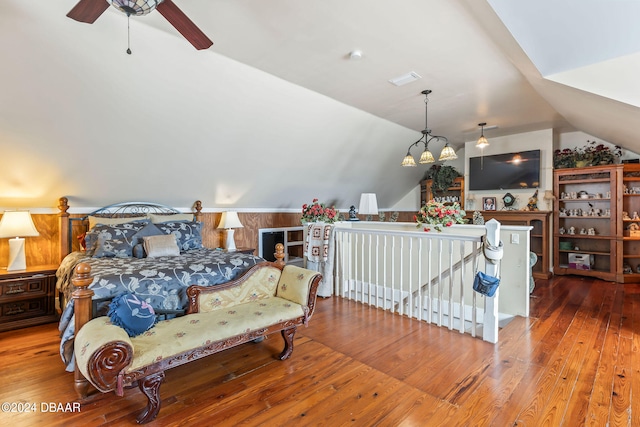 bedroom featuring hardwood / wood-style flooring, vaulted ceiling, and ceiling fan