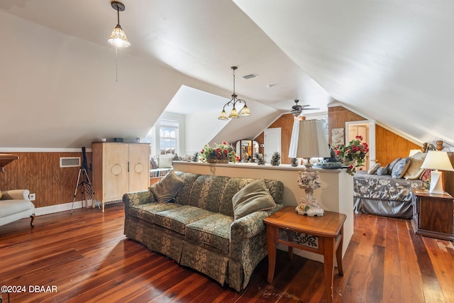 living room featuring dark hardwood / wood-style floors, lofted ceiling, and wooden walls