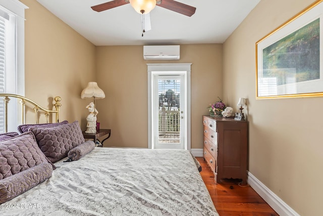 bedroom featuring access to outside, ceiling fan, dark hardwood / wood-style floors, and an AC wall unit